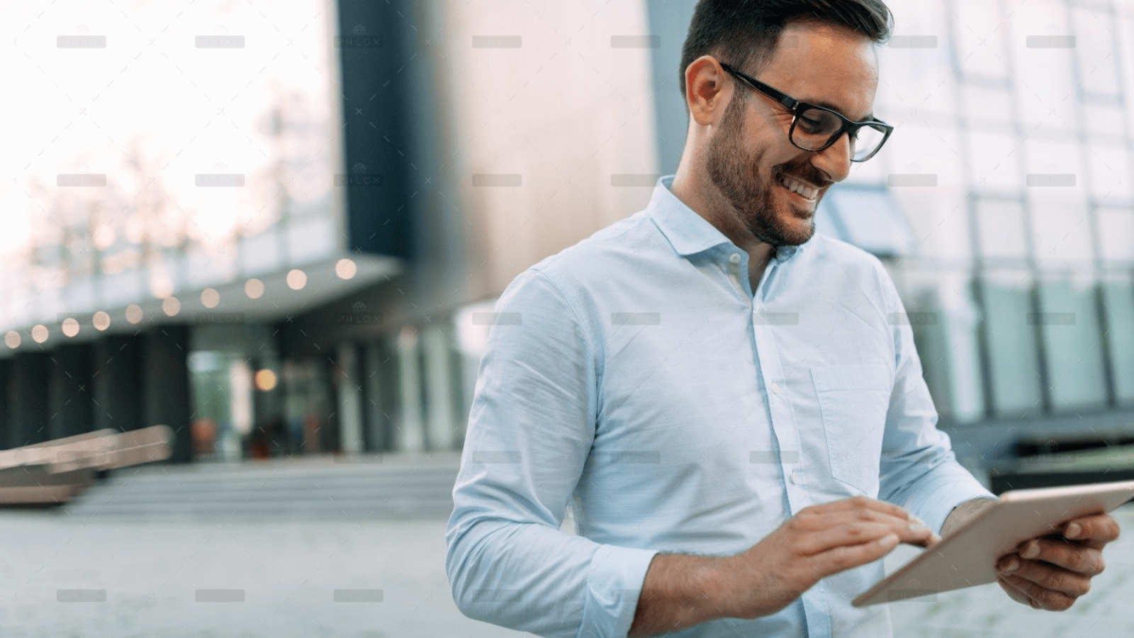 demo-attachment-467-portrait-of-businessman-in-glasses-holding-tablet-AWVHCJU